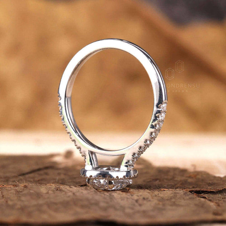 Cathedral setting engagement ring featuring a pave band design.
