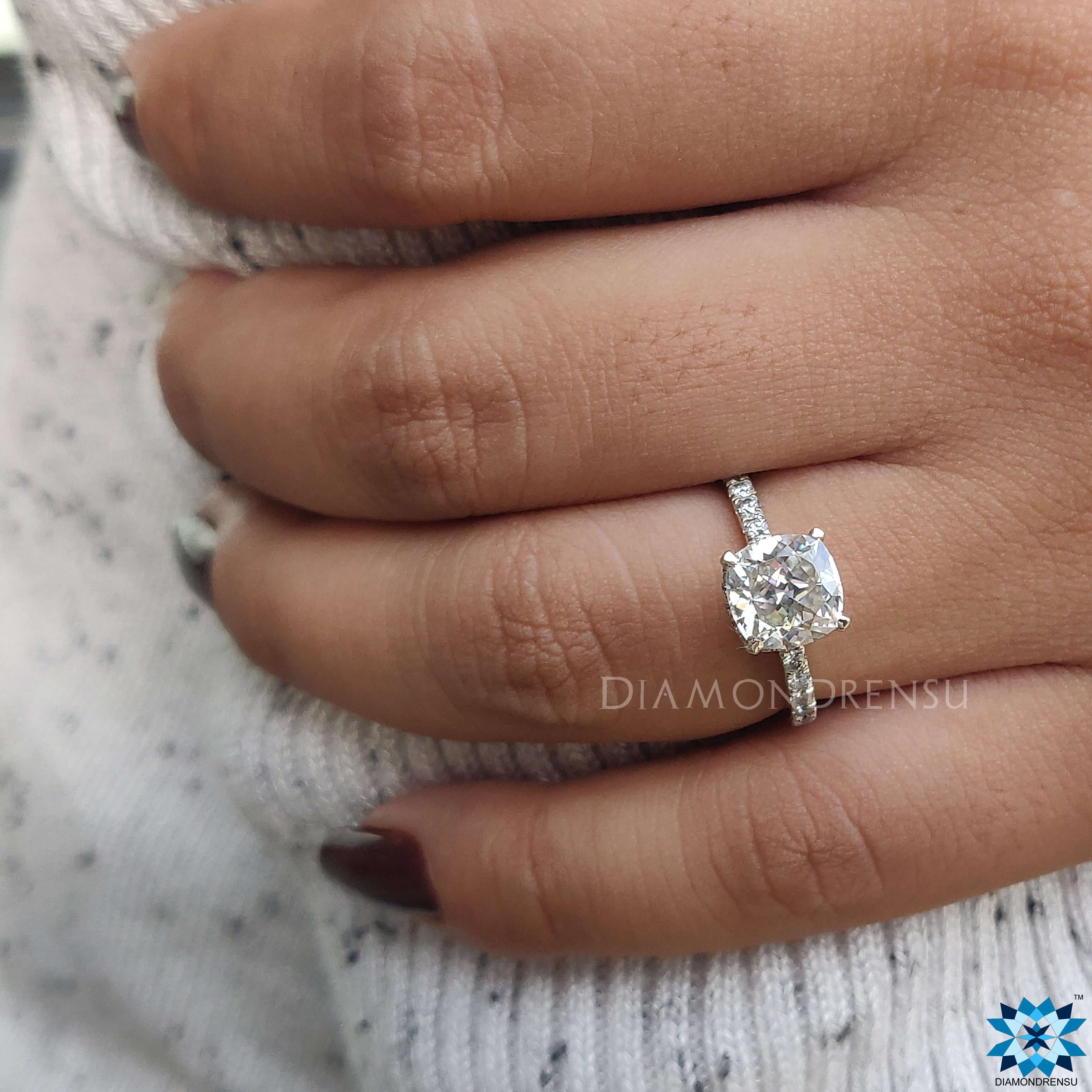 Cushion cut moissanite ring featuring a hidden halo ring design.