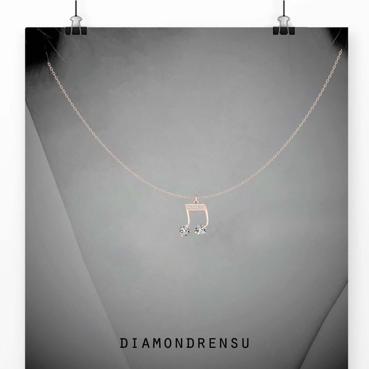Round diamond pendant in a musical note design.
