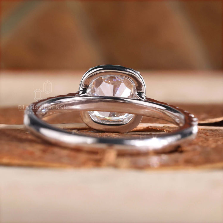 Cushion cut diamond ring featuring a pave band and white gold finish
