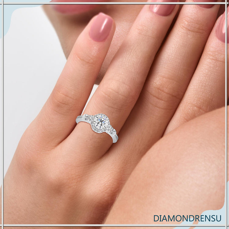 Round cut diamond ring with tulip-style floral design.
