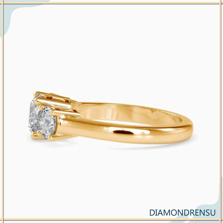 Yellow gold diamond ring featuring custom three stone layout.
