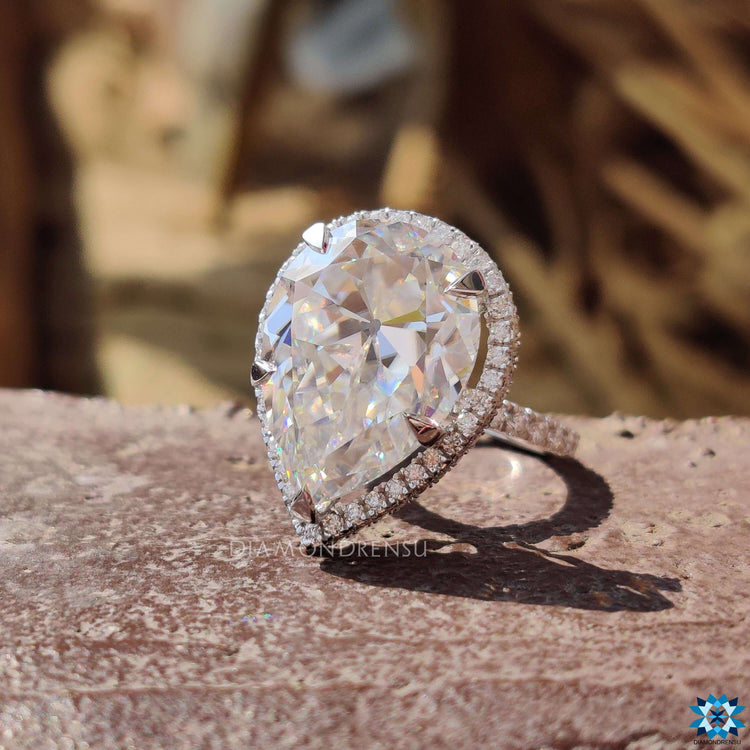 Custom moissanite ring with round pave setting and hidden halo design.
