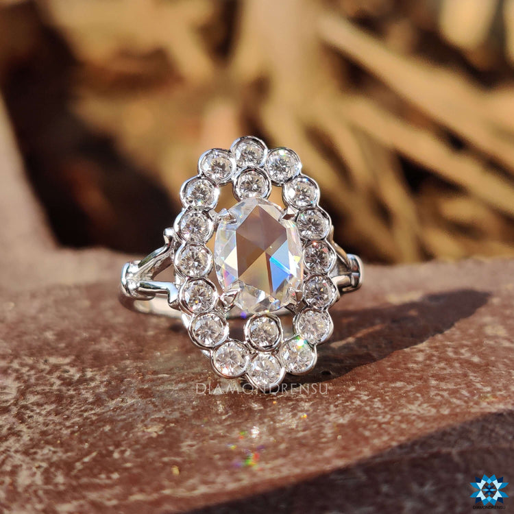 White gold ring featuring an antique vintage style halo design.
