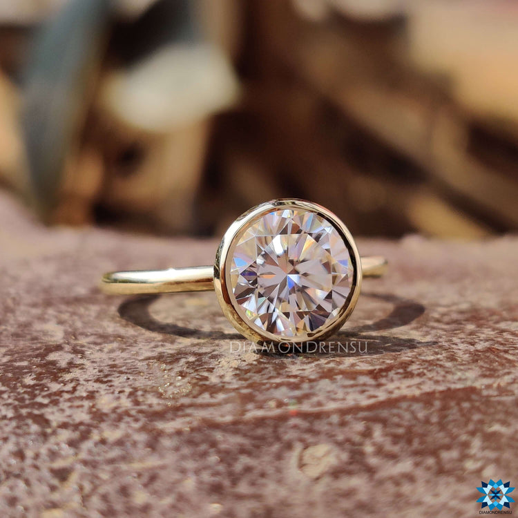 Round bezel engagement ring with a clean and secure setting.
