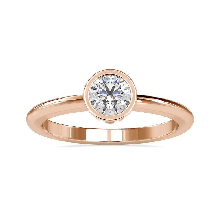 UK engagement ring with round cut diamond and bezel setting.
