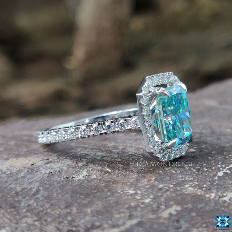 Moissanite engagement ring with pave band and halo design.
