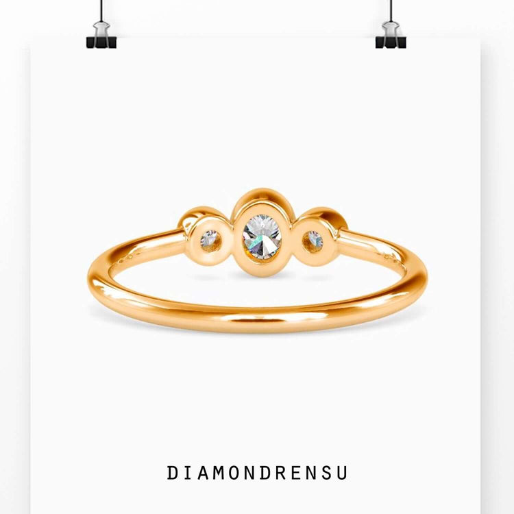 Diamondrensu UK engagement ring with bezel set oval and side stones.
