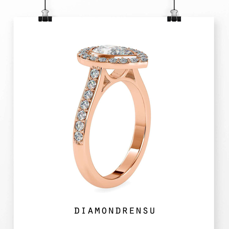 Pave setting ring with pear cut diamond and halo frame.
