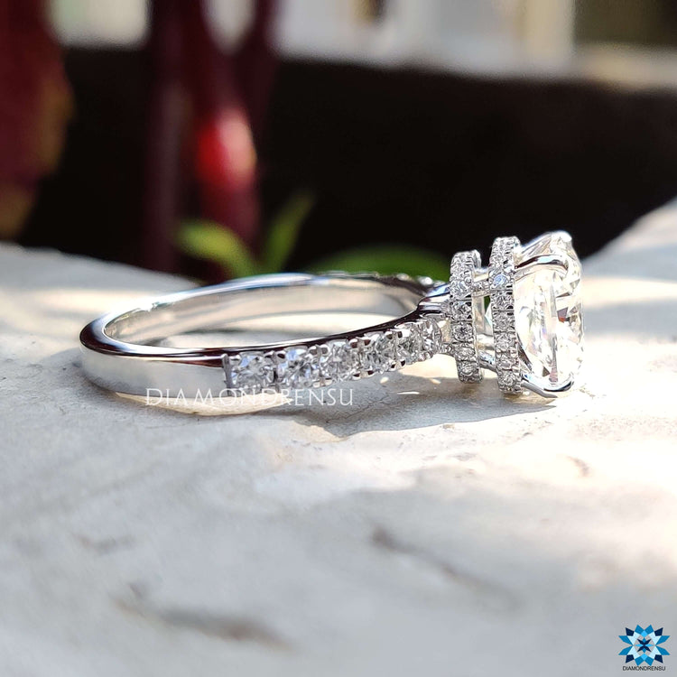 White gold engagement ring with cushion moissanite.

