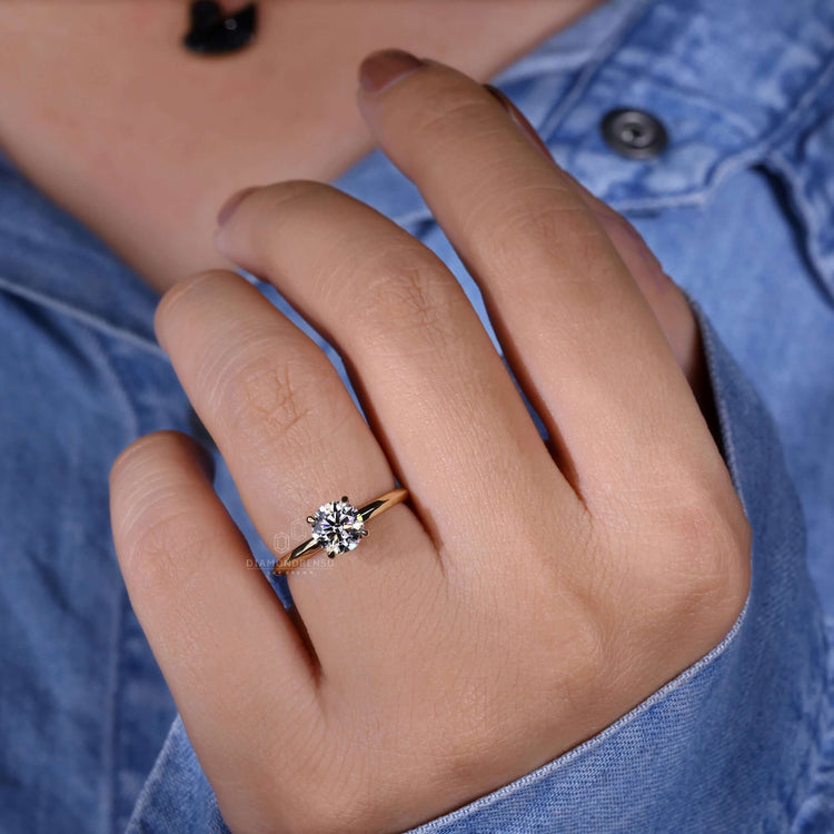 Round cut diamond ring with a claw prong setting, handmade in the UK for a modern engagement ring.
