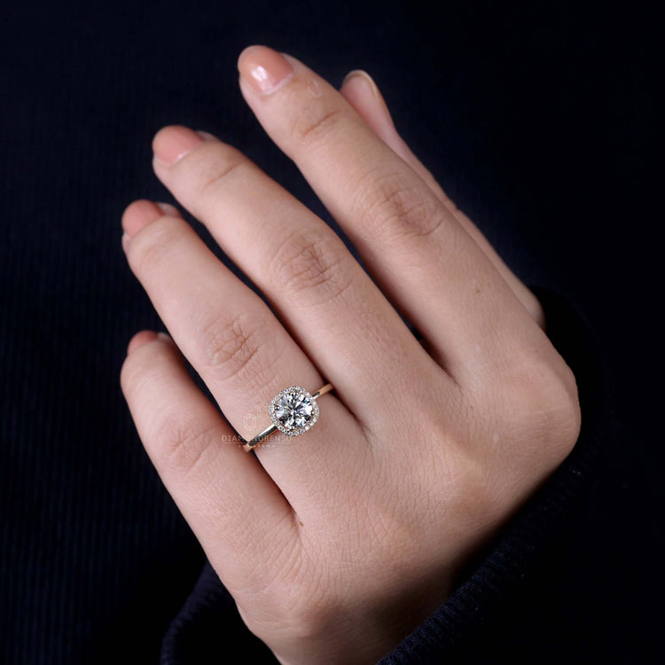 Round halo diamond ring with a gold halo ring band for a radiant finish.