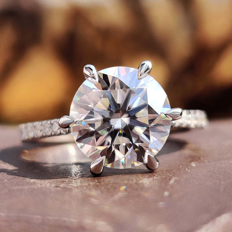 Round cut moissanite ring in cathedral setting.
