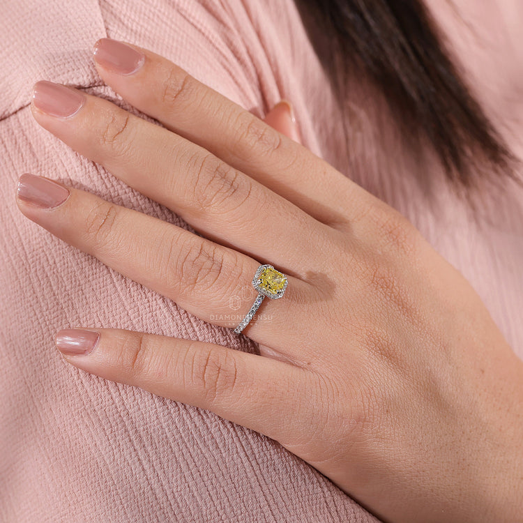 Fancy vivid yellow diamond ring set with double prongs.