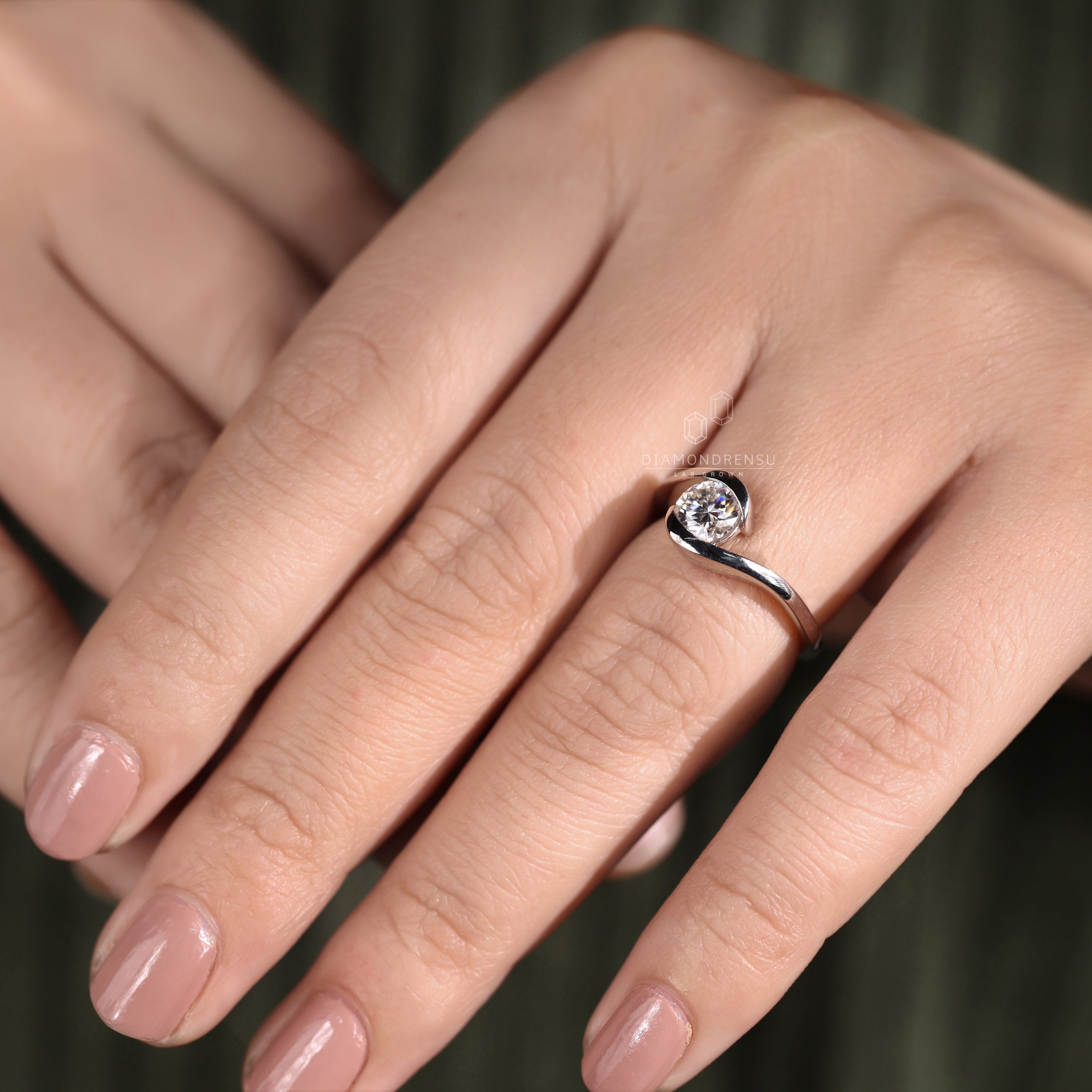 Round solitaire ring in white gold with intricate handmade detailing.