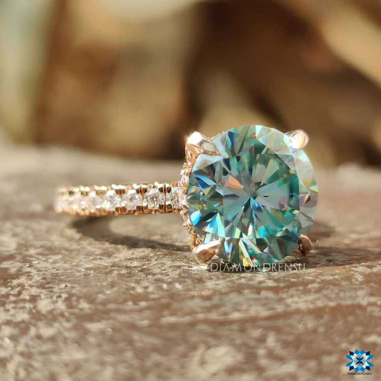 Rose gold moissanite pave ring with round cut center.
