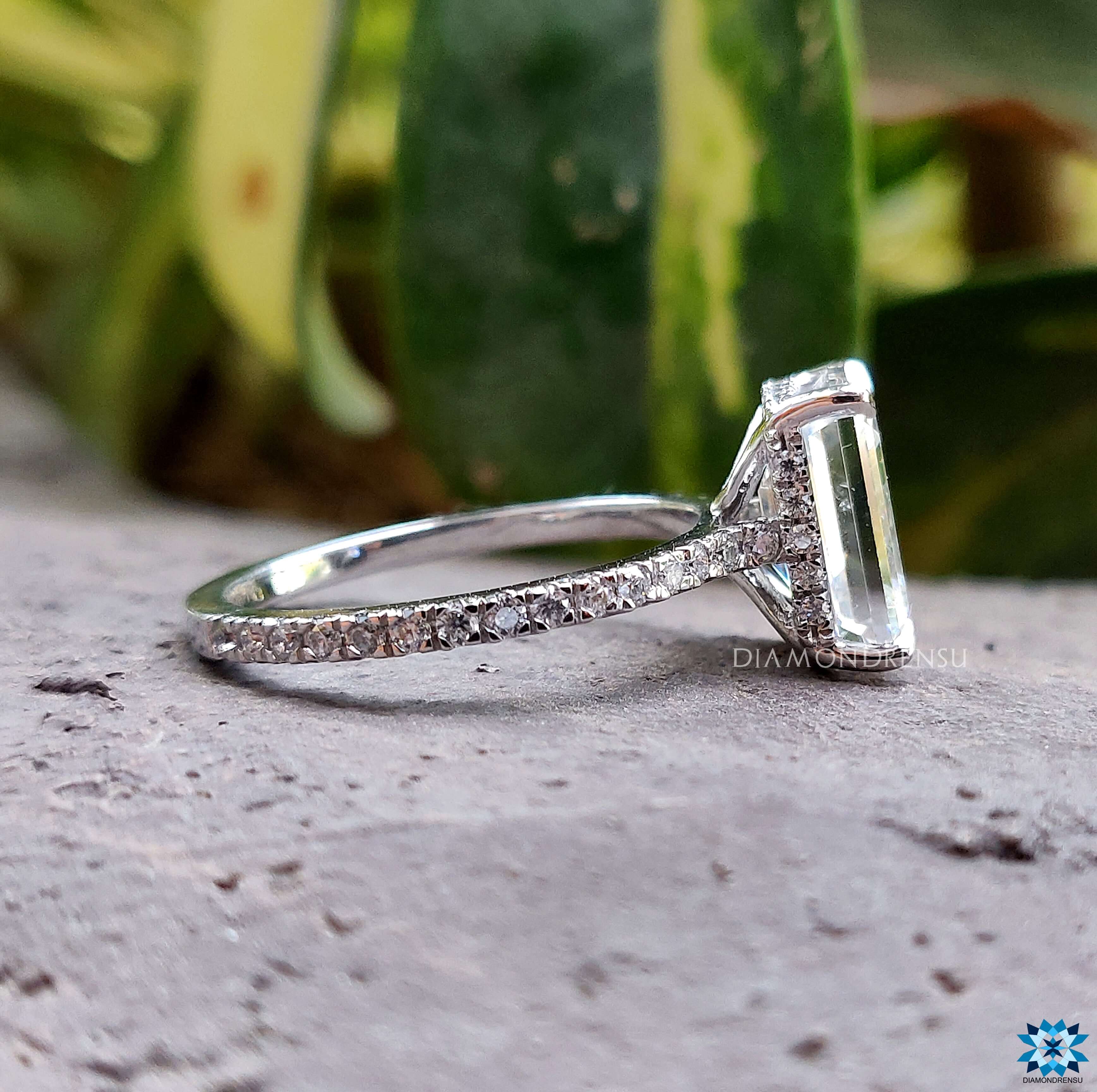 White gold engagement ring featuring an exquisite emerald cut moissanite ring.