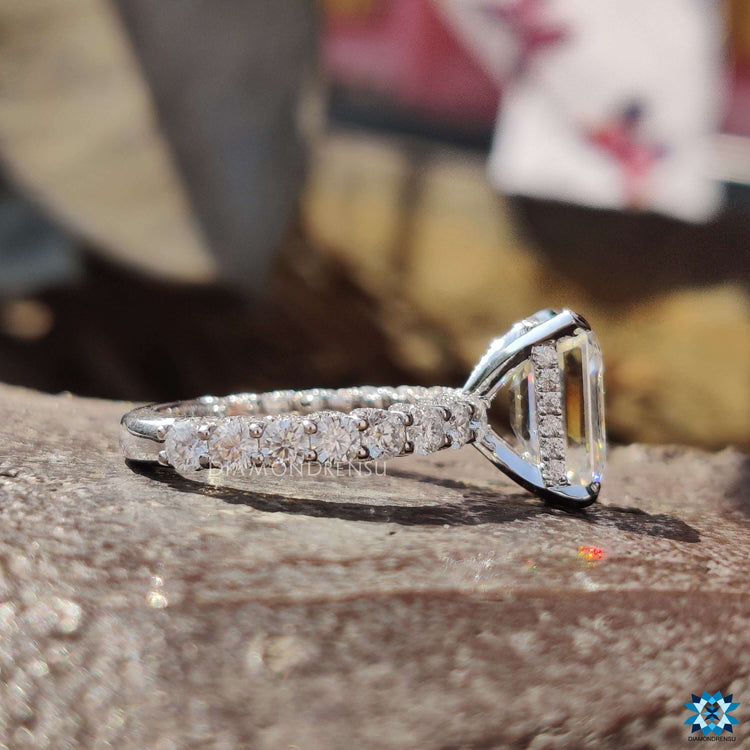 Pave setting ring with emerald cut moissanite center.
