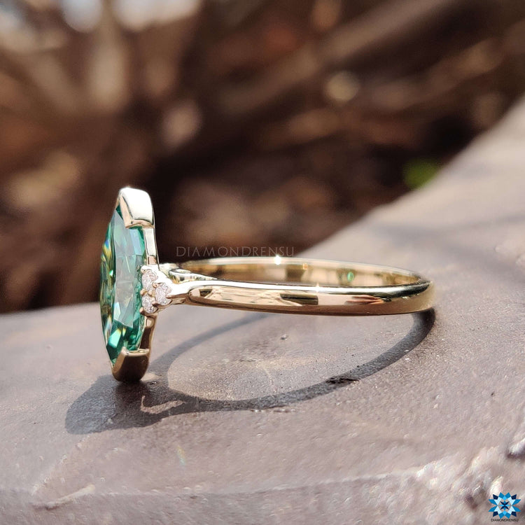 Muse-inspired engagement ring with green Dutch marquise center.
