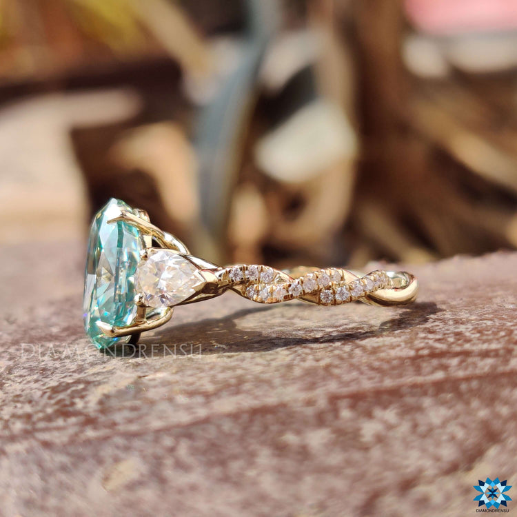 Handmade three stone ring with an oval moissanite center.
