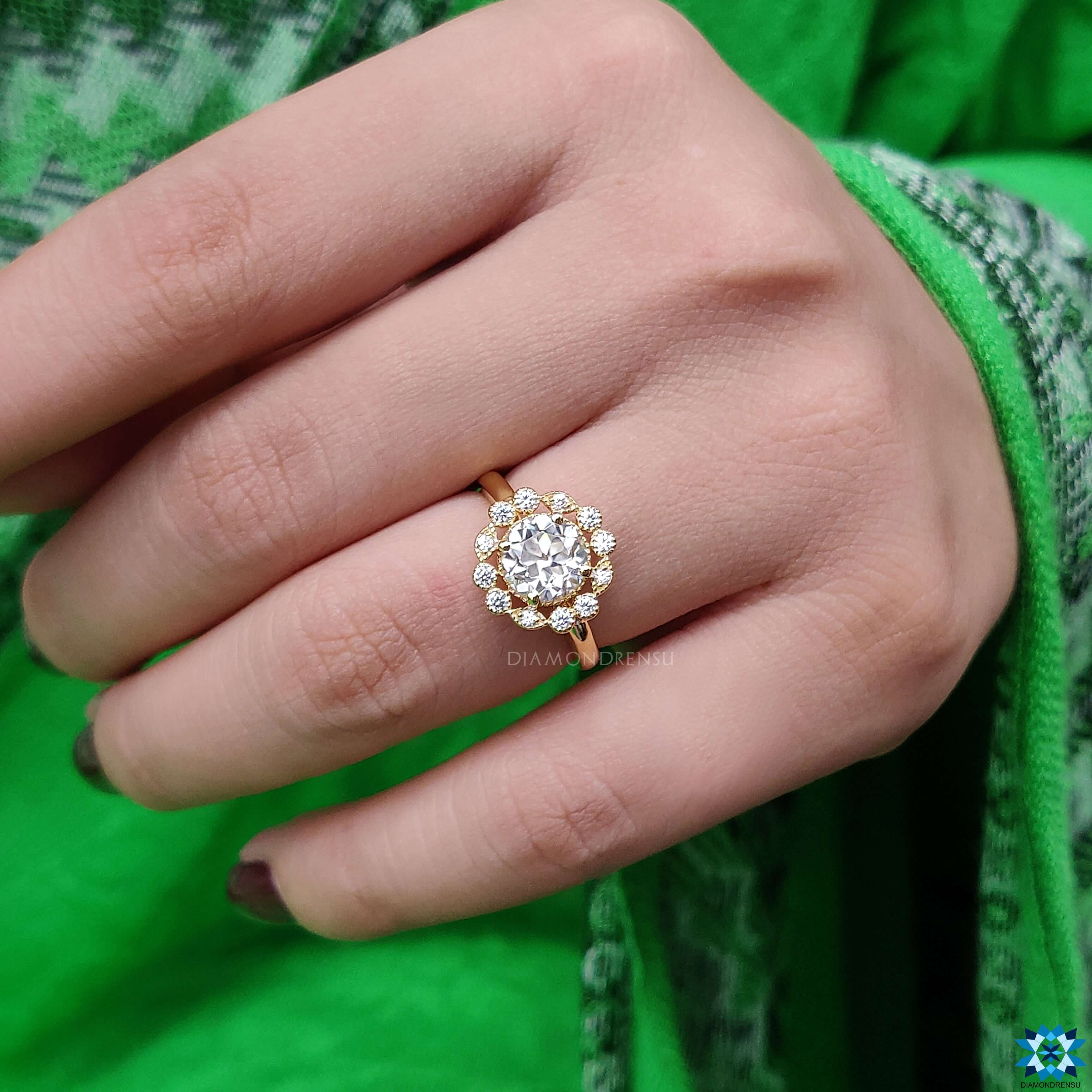 Handmade jewelry showcasing a round brilliant cut ring with milgrain detailing.