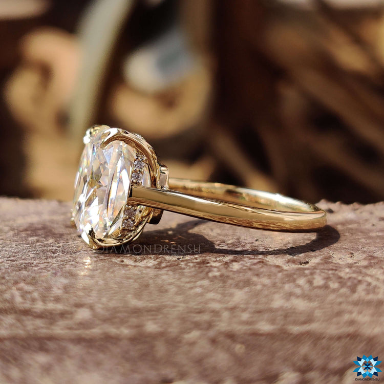 Cushion cut moissanite ring featuring hidden halo and prong setting.
