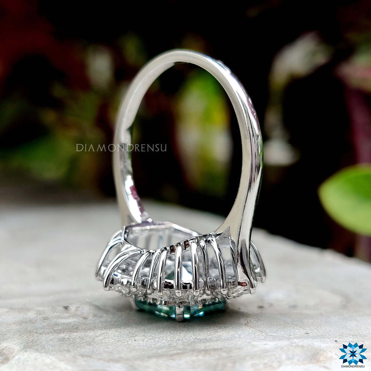 Custom vintage ring featuring radiant moissanite in halo style.
