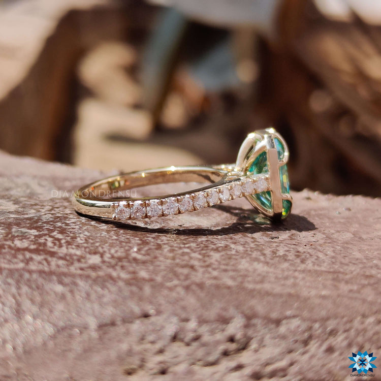 Custom engagement ring featuring green radiant cut moissanite.
