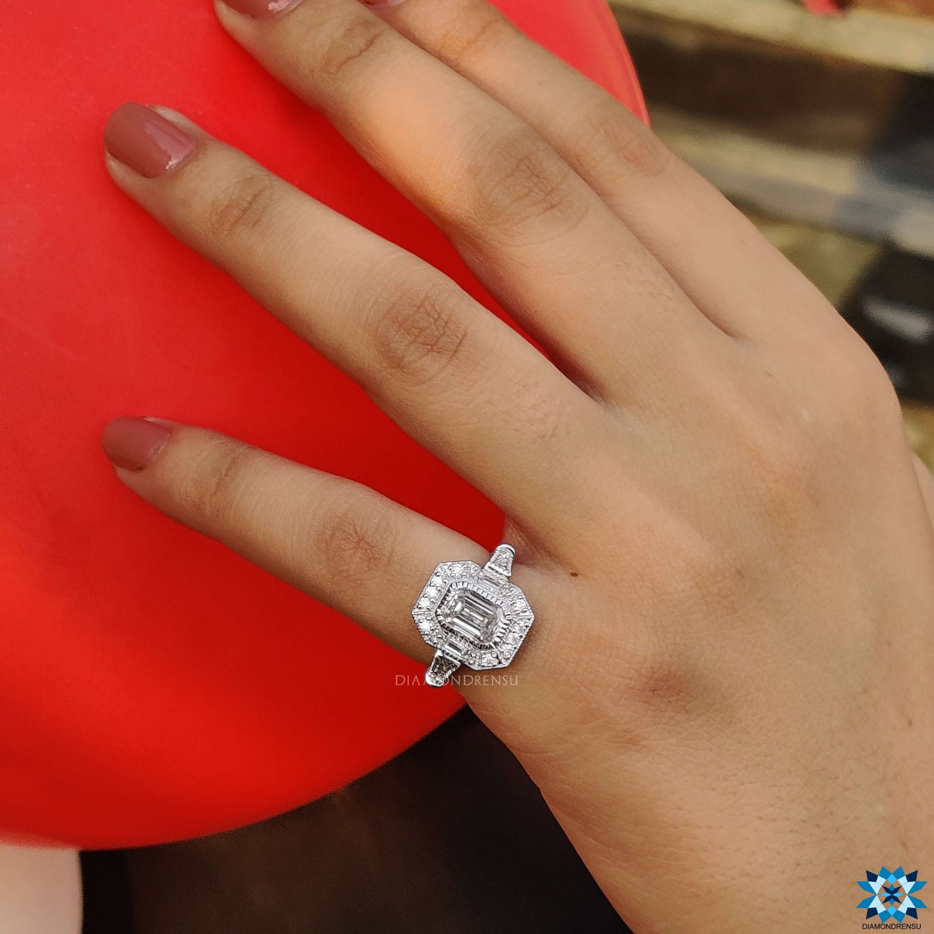 Diamondrensu UK engagement ring showcasing a stunning emerald cut ring with milgrain ring accents.