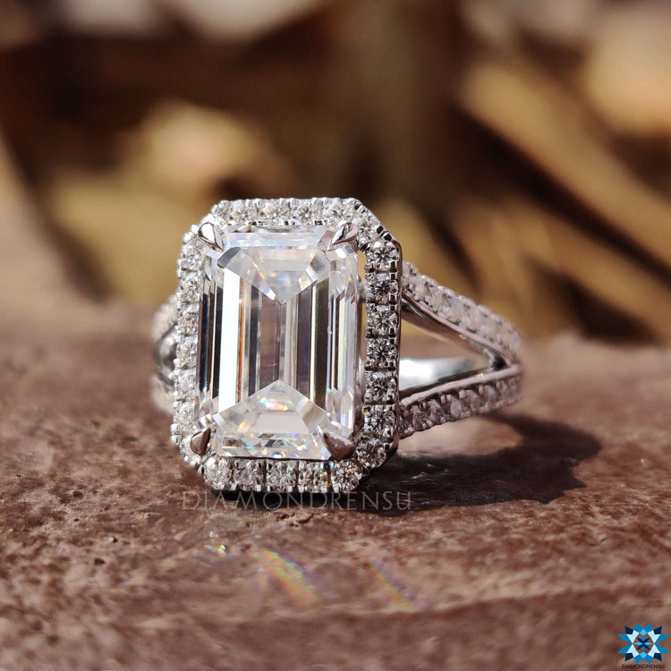 White gold ring featuring emerald moissanite center.
