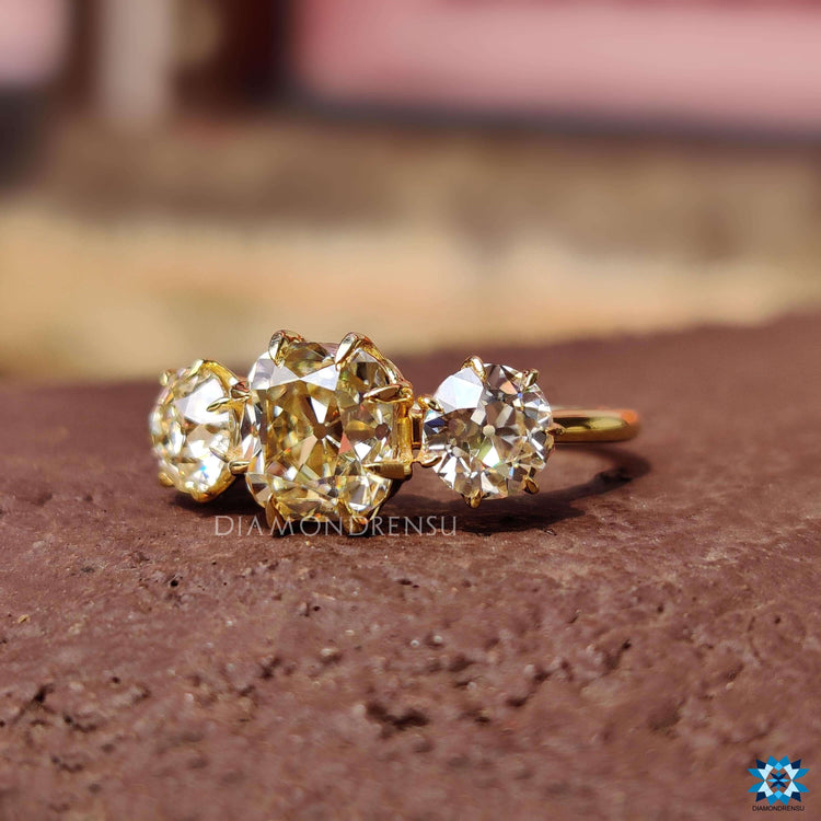 Light yellow cushion moissanite ring in 6 claw prong setting.
