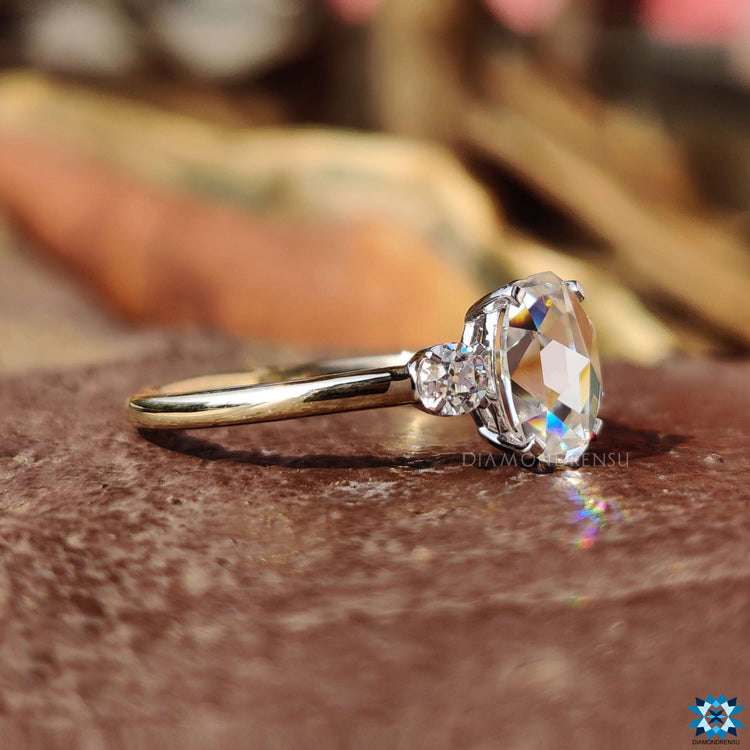 Handmade engagement ring featuring oval rose cut moissanite and old European sides.

