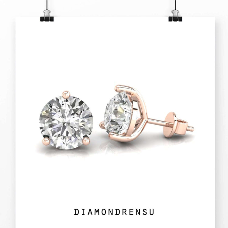 UK diamond earrings featuring round cut diamonds in gold stud style.
