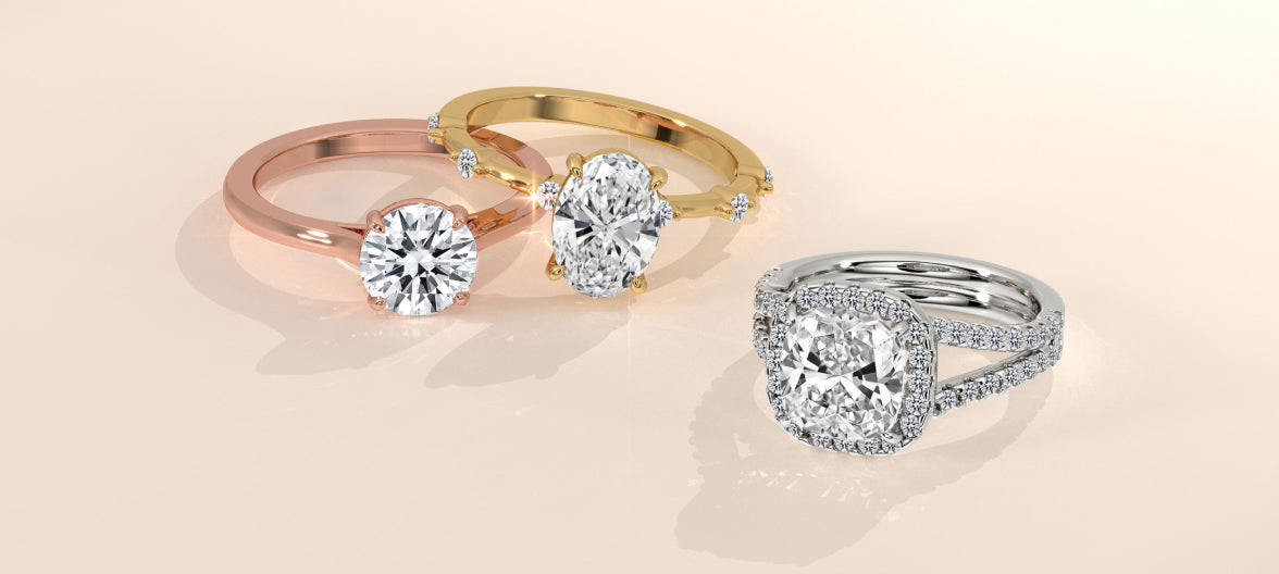 This engagement rings in rose gold, yellow gold, and white gold settings featuring round, oval, and cushion cut center stones, displayed on a soft beige background.