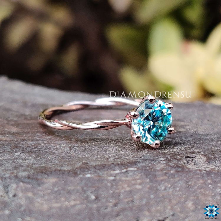 Cyan blue moissanite ring set in a 6 prong design.
