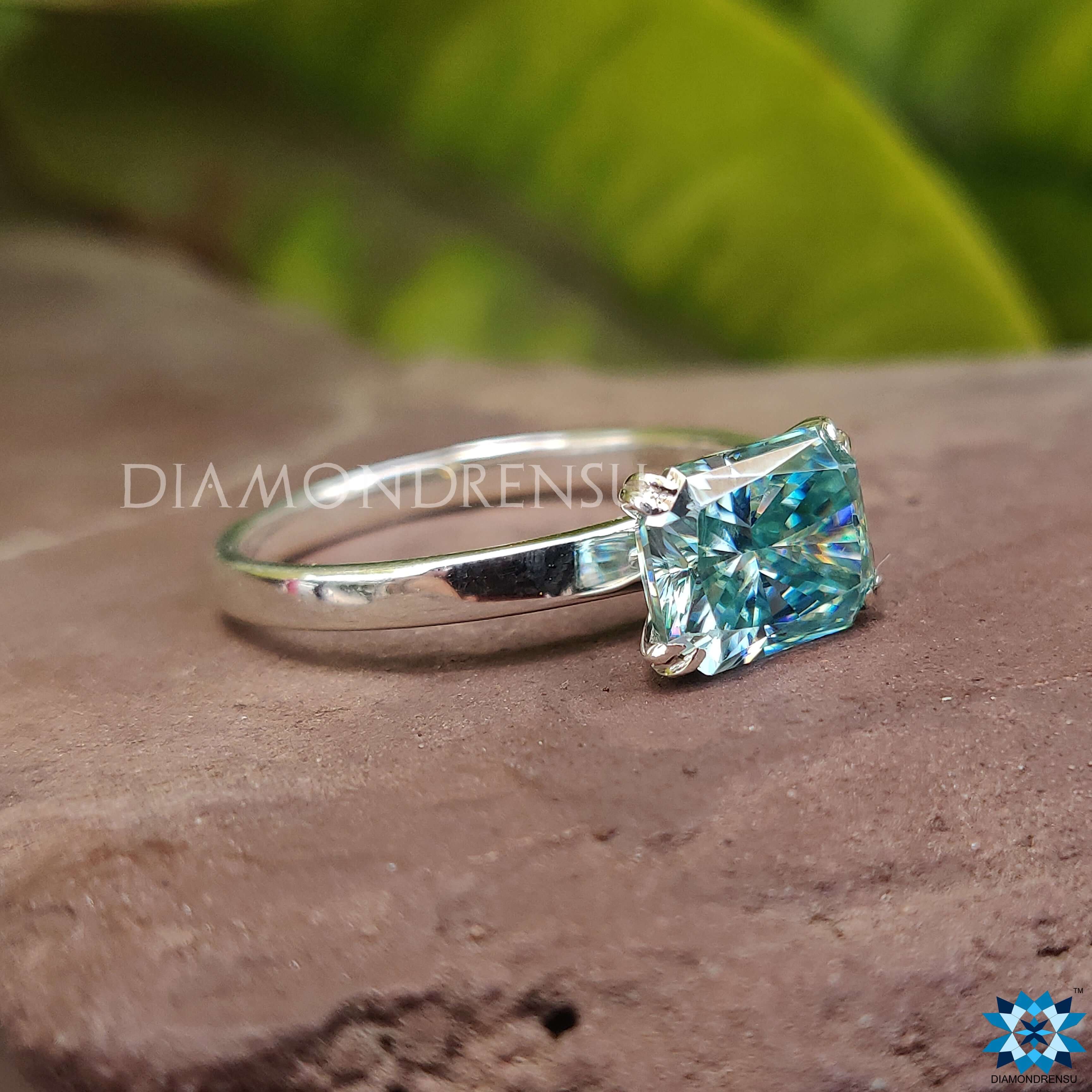 White gold ring with a radiant cut moissanite stone.