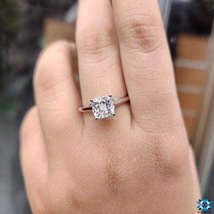 Cushion cut moissanite solitaire ring in white gold for a minimal look.
