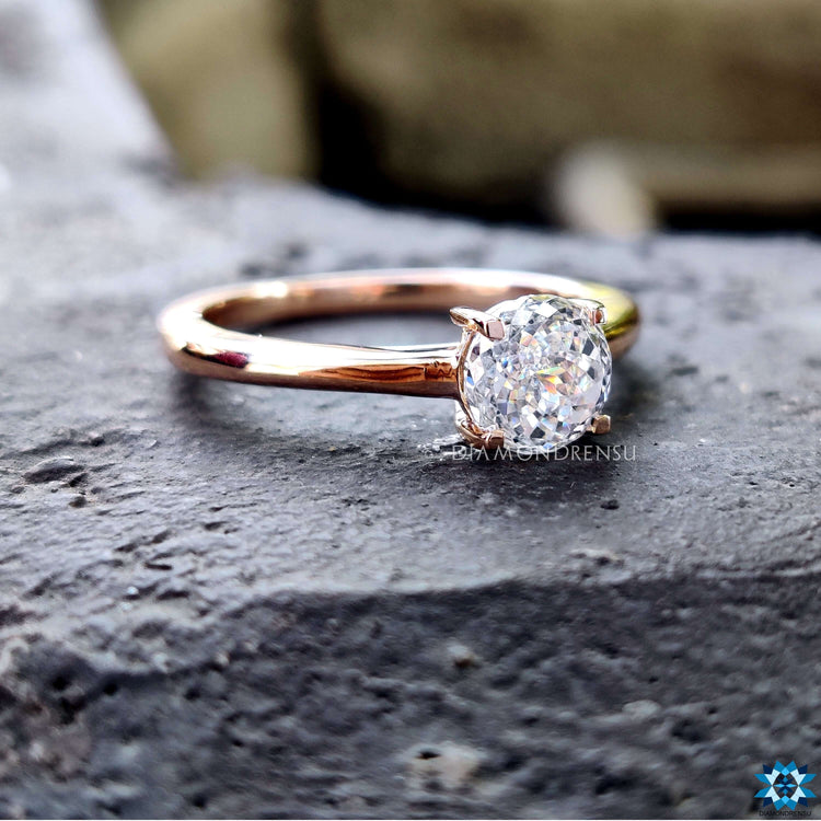 Rose gold ring featuring Portuguese cut moissanite.
