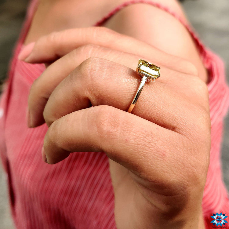 Yellow gold ring with radiant cut moissanite stone.
