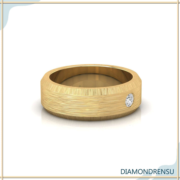 Mens wedding ring in yellow gold with flush setting and diamond detail.
