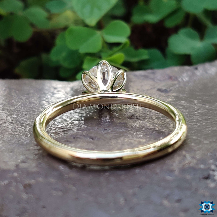 Solitaire engagement ring in yellow gold with prong mount.
