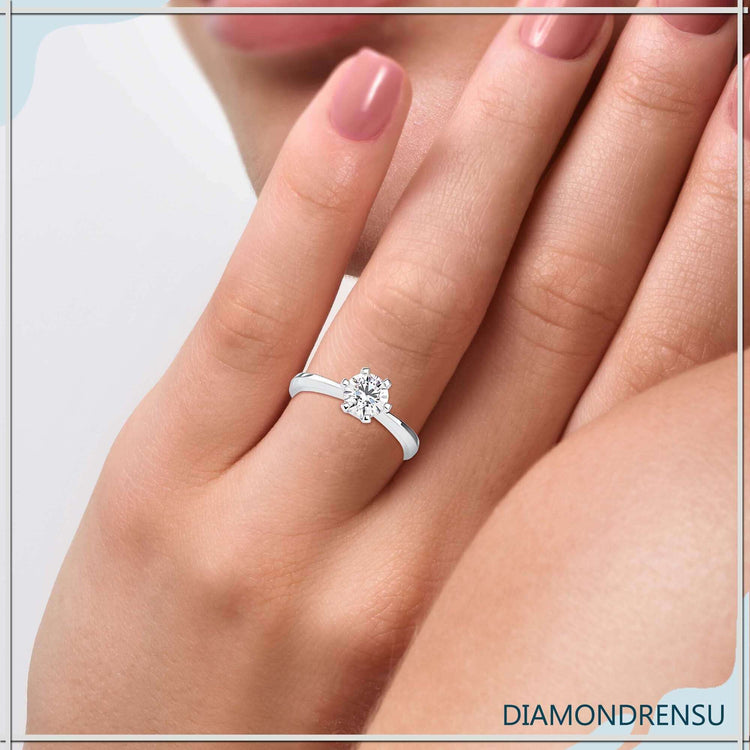 Round cut diamond ring with tab prong solitaire design.
