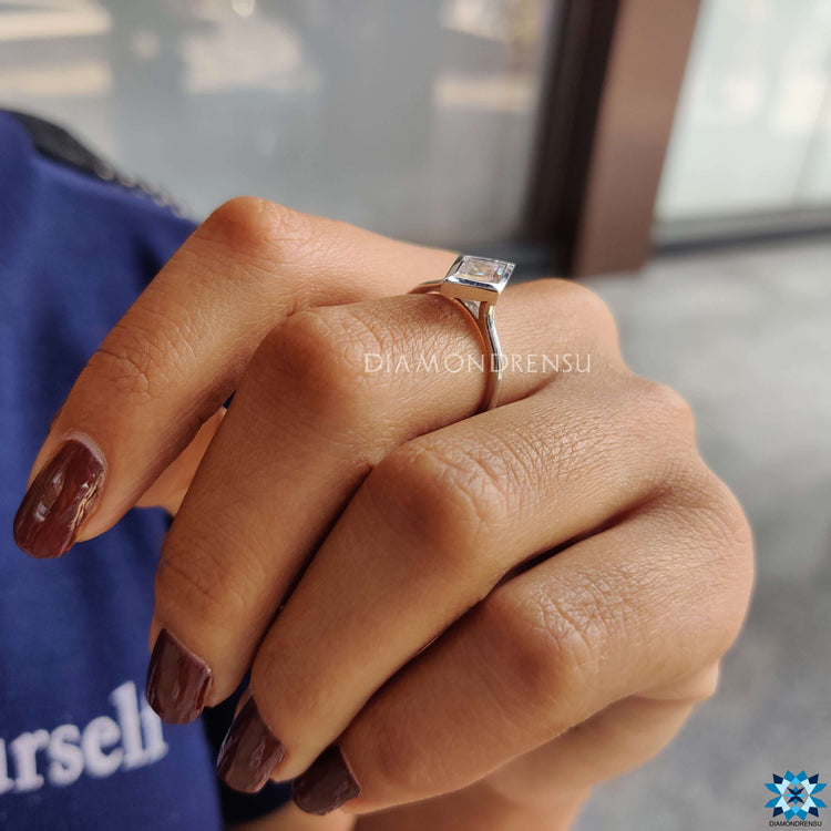 White gold engagement ring with prong and bezel details.
