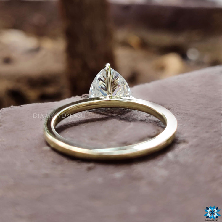 Custom engagement ring with trillion cut stone.
