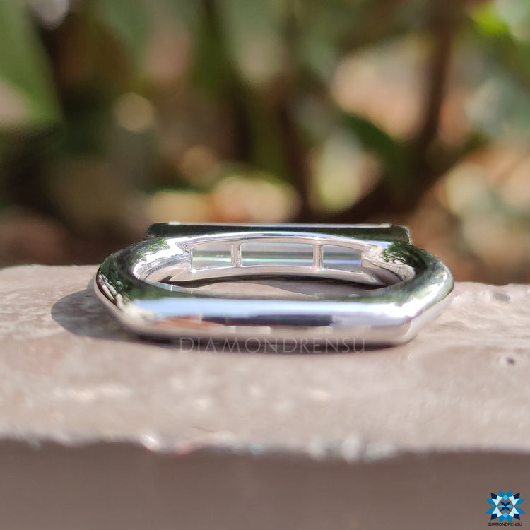 East west engagement ring featuring baguette stone.

