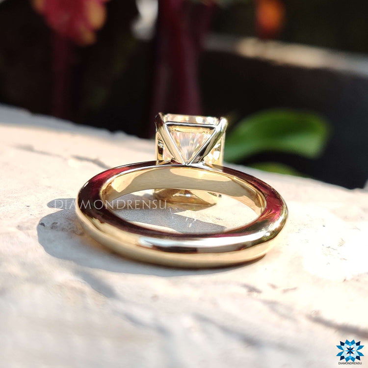 Solitaire style radiant cut moissanite ring in four prong setting.
