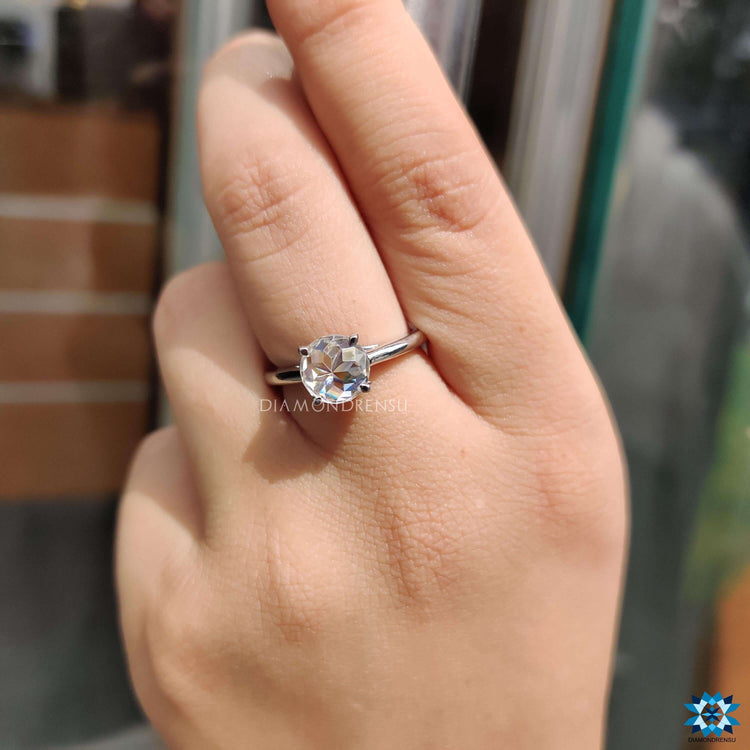 White gold solitaire ring with round rose cut moissanite.
