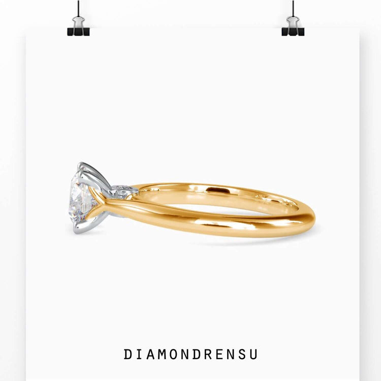UK engagement ring in yellow gold with round cut diamond.
