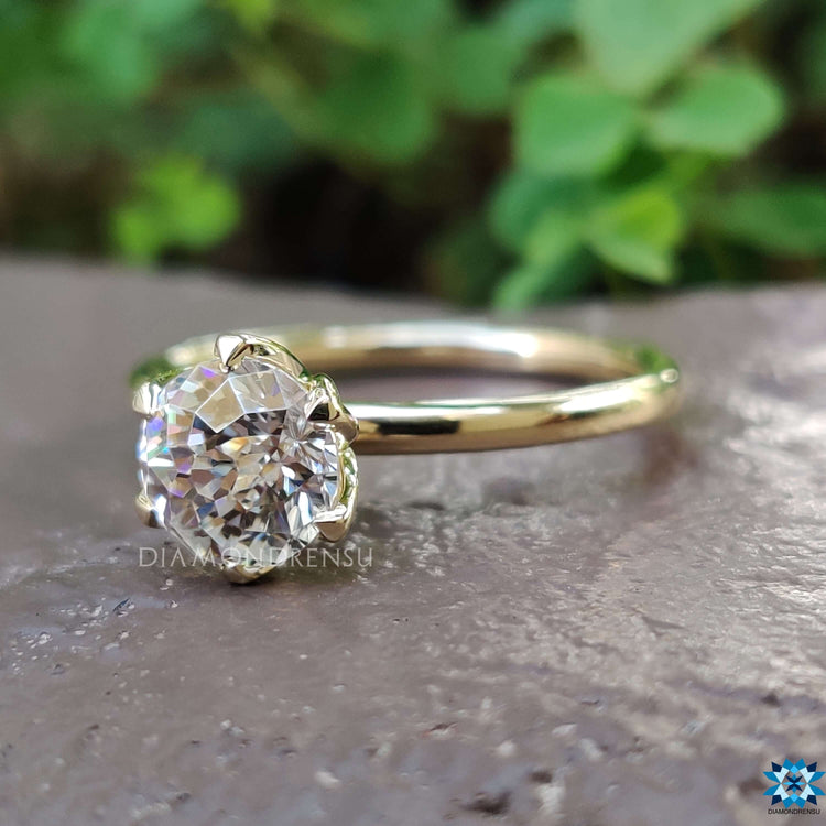 Custom round moissanite ring in tulip-style setting.
