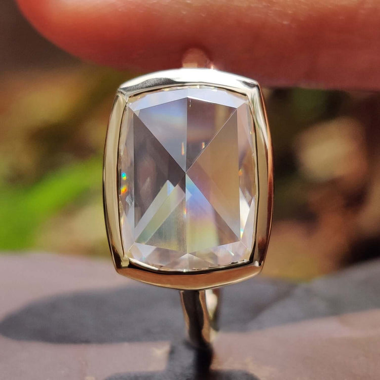 Bezel solitaire engagement ring in yellow gold.
